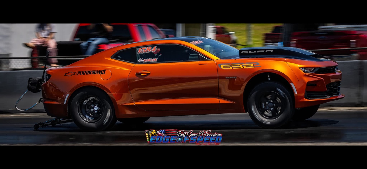 Orange COPO Camaro side profile at speed